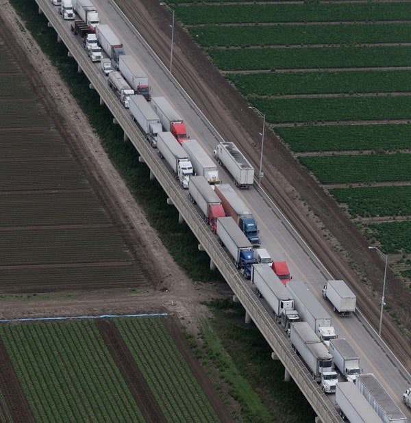 Trucks wait in line on the Pharr International Bridge near the Texas-Mexico border, Feb. 24, 2015. (AP Photo/Eric Gay)