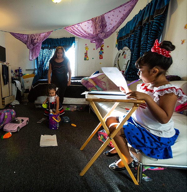 Melina Vasquez supervises homework time. 84% of Hispanic parents have a specific place set aside for homework. [NCES, Parent and Family Involvement in Education, from the National Household Education Surveys program of 2012]