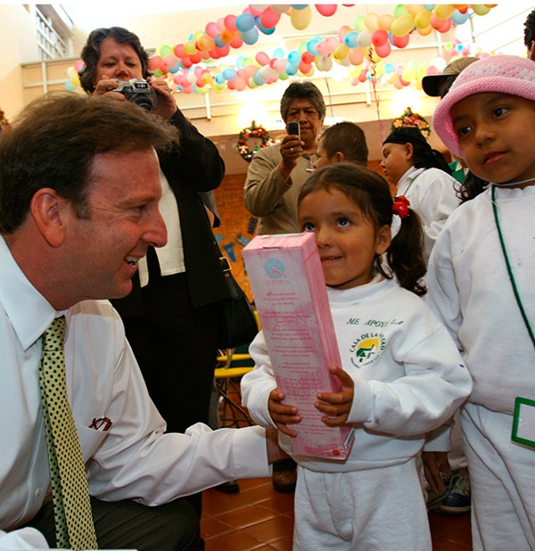 Ambassador Antonio Garza gives a Christmas gift to a child at the Casa de la Amistad home for children with cancer in Mexico City, Mexico on Dec. 15, 2005. (AP Photo/Marco Ugarte)