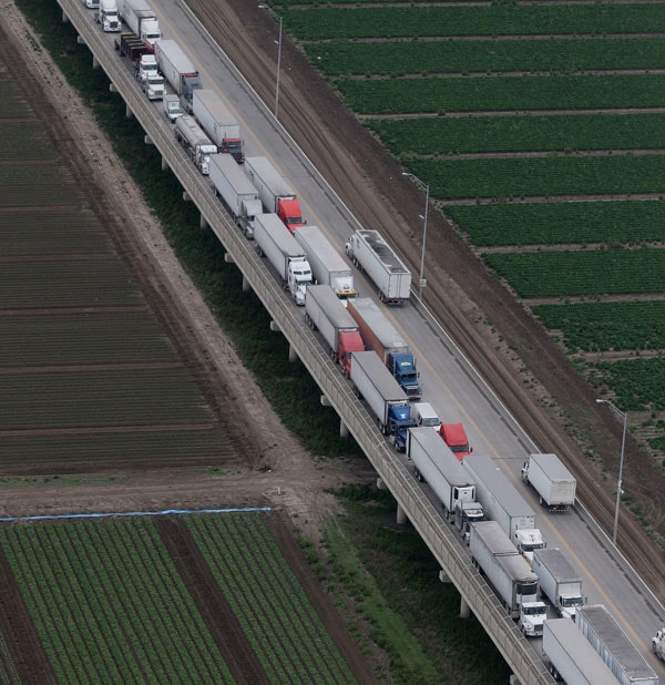 Trucks wait in line on the Pharr International Bridge near the Texas-Mexico border, Feb. 24, 2015.  (AP Photo/Eric Gay)