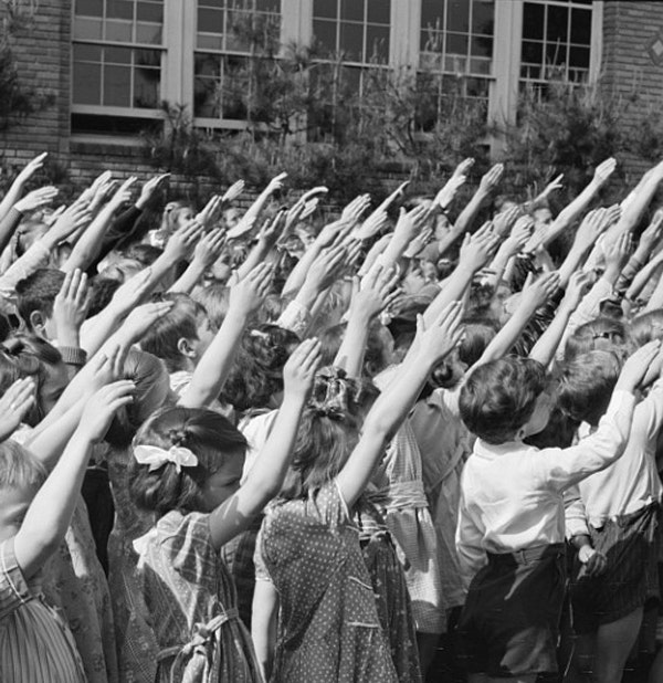 As part of the Pledge of Allegiance, students in 1942 perform the Bellamy Salute.  Religious freedom advocates felt that requiring the Pledge violated First Amendment rights. (Library of Congress)