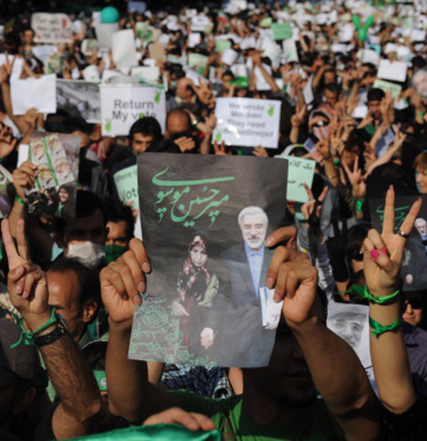 Demonstrators carry banners and pictures of Mir Hossein Mousavi, the defeated reformist candidate, during a march on Karimkhan Street, Tehran, June 17, 2009. (Kaveh Kazemi/Getty Images)