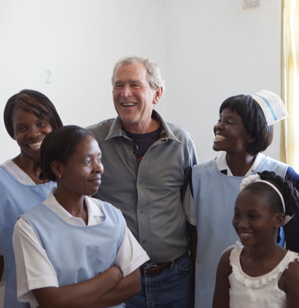  President Bush and local community members at the Ngungu Health Center, which was renovated as part of Pink Ribbon Red Ribbon, July 3, 2012. (Shealah Craighead/George W. Bush Presidential Center)