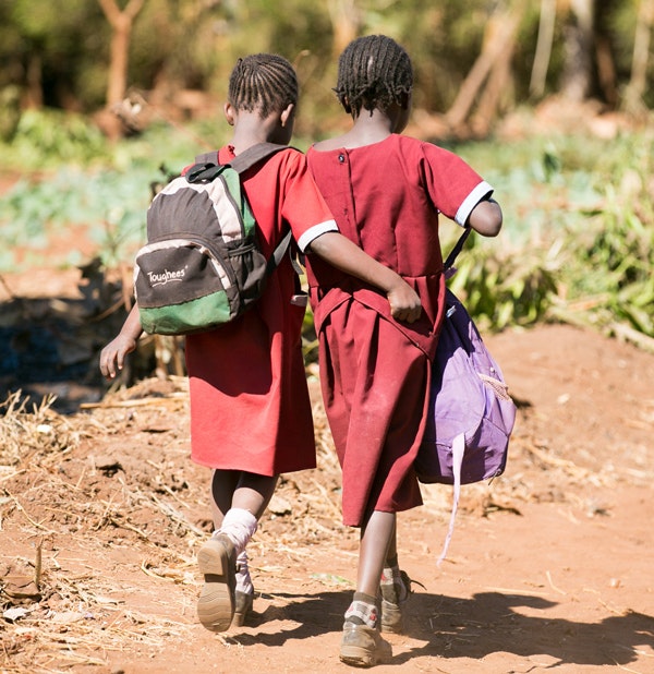 Girls walk with their book bags in Zambia in 2013. (Paul Morse / George W. Bush Presidential Center)