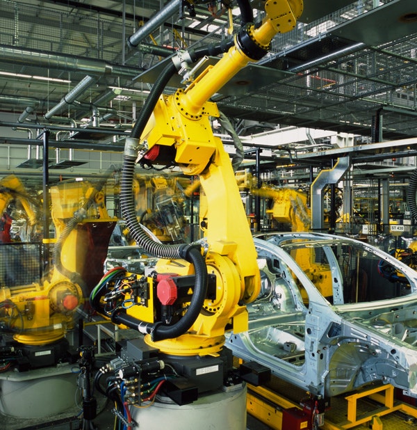 Robots working on cars on an assembly line